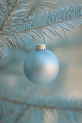 A vibrant blue ornament dangles gracefully from a delicate tree branch, capturing the essence of festive cheer and seasonal beauty.