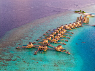 Aerial views of Velavaru Island at sunset in Maldives