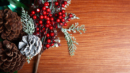 Christmas decoration detail. Red and gold Christmas decorations such as ribbon, fir branches, pine cones and Christmas tree. Background.