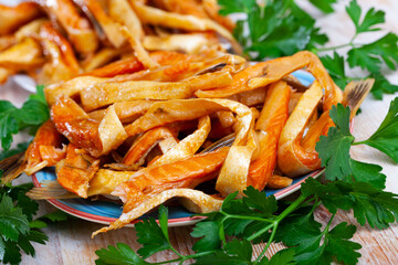 Appetizing smoked salmon belly strips with fresh parsley on plate. Popular fish snack