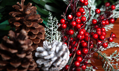 Christmas decoration detail. Red and gold, decorations such as ribbon, fir branches and pine cones.