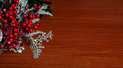 Christmas decoration detail. Red and gold Christmas decorations such as ribbon, fir branches, pine cones and Christmas tree. Background.