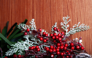 Christmas decoration detail. Red and gold Christmas decorations such as ribbon, fir branches, pine cones and Christmas tree. Background.