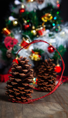 Christmas decoration detail. Red and gold, decorations such as ribbon, fir branches and pine cones.