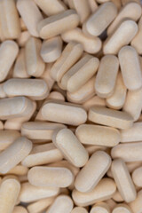 Close Up of a variety of yellow pharmaceutical pills, vitamins, antibiotics, capsules concept of pharmacy, health, medicine, business, pharmaceutical, background. selective focus.