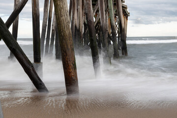 Fishing pier with crashing waves