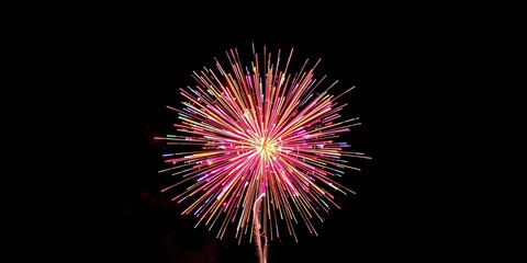 Fototapeta premium Colorful explosions of light and sound from a spherical firework exploding in mid-air, bright lights, explosion