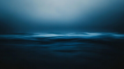 Obraz premium Calm blue ocean waves under a cloudy sky at twilight with gentle movement and serene atmosphere