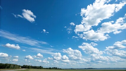 serene blue sky with fluffy white clouds scattered across the horizon, nature, horizon