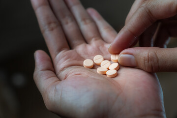 Women hands holding pills of vitamin or supplement. Healthcare and medical concept