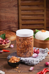 Fried shallots in a jar with a darkmood photo concept and onion photo display