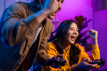 Asian Esport couple gamer playing online video game on computer.  © Pavitra