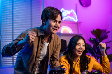 Asian Esport couple gamer playing online video game on computer. 