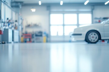 Fototapeta premium Blurred view of a white car in a garage with tools and equipment in the background.