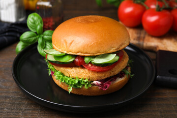 Delicious vegan burger with chickpea cutlet on wooden table, closeup