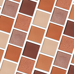 Fototapeta premium Eyeshadow palette, mix of matte and shimmer shades in brown, nude, orange hues. Aesthetic top view pattern for beauty, makeup, cosmetics themes, Neutral colored swatches eyeshade refills