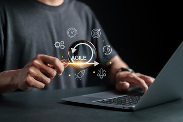 Agile development methodology concept, Person using laptop with agile icons on virtual screen....