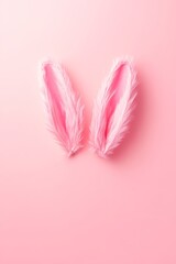 Playful pink bunny ears adorned with soft white feathers stand out against a vibrant pink background, evoking whimsy and festive cheer.