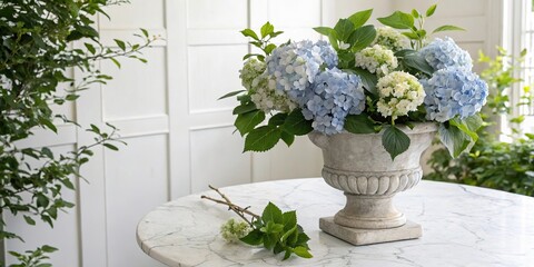 Hydrangea flowers in a stone vase on a white marble table with greenery around it, flower, vase, outdoor decor, hydrangea