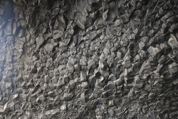 Reynisfjara black-sand beach found on the Ocean South Coast of Iceland, basalt columns and the dramatic Reynisdrangar sea stacks. Iceland, Europe.