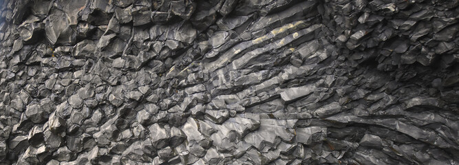 Reynisfjara black-sand beach found on the Ocean South Coast of Iceland, basalt columns and the dramatic Reynisdrangar sea stacks. Iceland, Europe.