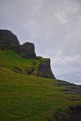 Reynisfjara black-sand beach found on the Ocean South Coast of Iceland, basalt columns and the dramatic Reynisdrangar sea stacks. Iceland, Europe.