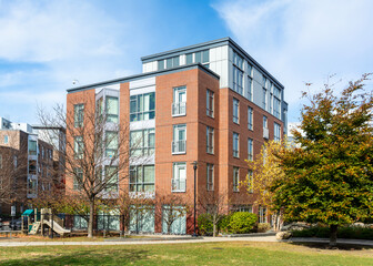 Multi-story brick apartment complex with green space and playground in Brighton, Massachusetts, USA

