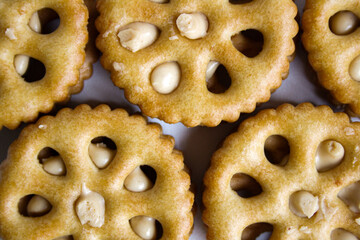 Close-up view of sandwich biscuits filled with peanut butter flavored cream on white background