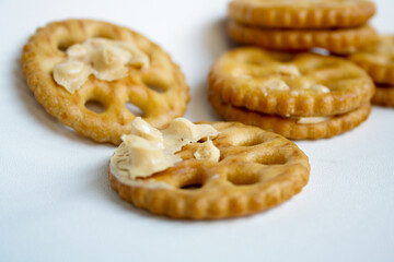 An open sandwich biscuits filled with peanut butter flavored cream on white background