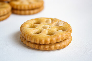Close-up view of sandwich biscuits filled with peanut butter flavored cream on white background