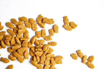 Scattered dry cat food isolated on white background