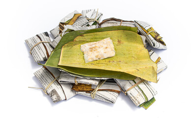 Fresh tempeh isolated on white background, Indonesian traditional food. Banana leaf and paper-wrapped tempeh is known tasty than the plastic-wrapped one