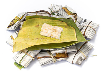 Fresh tempeh isolated on white background, Indonesian traditional food. Banana leaf and paper-wrapped tempeh is known tasty than the plastic-wrapped one