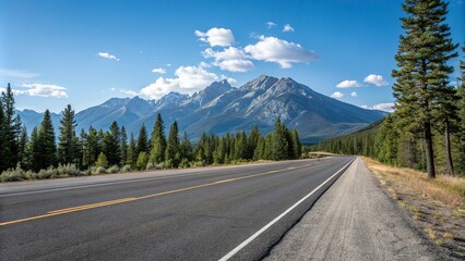 Fototapeta premium Empty stretch of asphalt road running parallel to a mountain range with a clear blue sky above and pine trees in the foreground, serene atmosphere, calmness, road to nowhere, empty highway