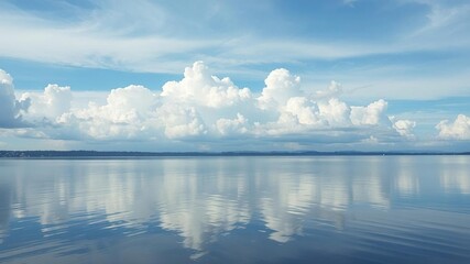 Obraz premium Ethereal clouds drift lazily across a calm lake, reflective water, serene atmosphere