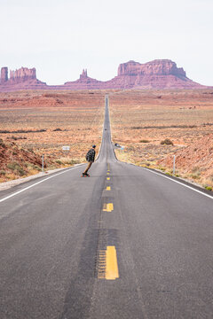 Skateboarding down a road in Monument Valley