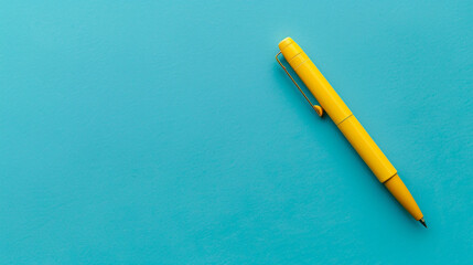 Top view of a sleek ballpoint pen on a blue background