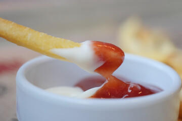 A French Fry that has been Dipped in a Mixture of Ketchup and Mayonnaise for flavor