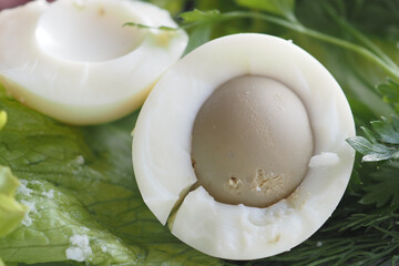 A Delicious Soft Boiled Egg Featuring Unique Coloration Accompanied by Fresh Greens