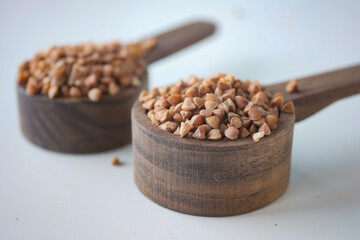 Close-Up of Buckwheat Kernels in Wooden Measuring Spoon