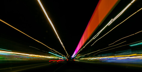 Abstract light streaks in multicoloured lines converging in a futuristic perspective