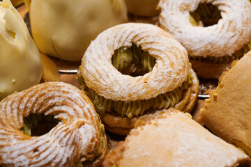 An array of pastries and eclairs are presented in the bakery display case with allure