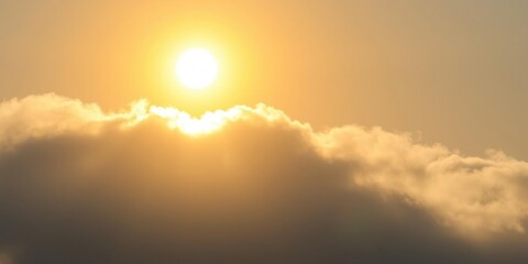 Fototapeta premium A bright yellow sun shines above a thin layer of dark grey and white cloudy skies with a hint of blue, airy, clear