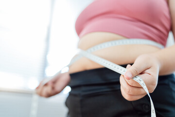 Obese Woman with fat belly in dieting concept. Overweight woman touching his fat belly and want to...
