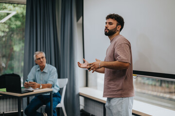 A young man speaks confidently while delivering a presentation to an engaged audience. The setting is professional, suggesting a business meeting or educational seminar.