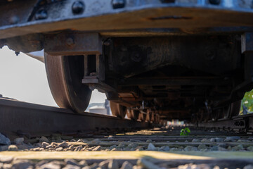 Track level view of a railroad train and wheels as they cross over