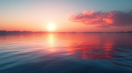 Obraz premium Serene sunset over calm water, reflecting vibrant colors.