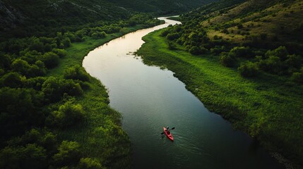 Kayak adventure on winding river with lush greenery and hills