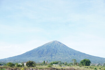 Fototapeta premium A majestic mountain with a conical shape and lush green slopes