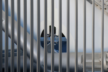 Intricate arrangement of metal pipes and barriers in an industrial setting during daylight hours